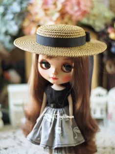 a doll with long hair wearing a hat