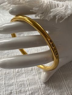 This is a lovely signed gold vermeil bangle bracelet, made in England. It is fully hallmarked , and in excellent, vintage condition. The bracelet is beautifully made, and weighs 60g. The bracelet measures 7 5/8 inches inside. It is perfect for a larger wrist. It is stylish and appropriate for a male or female. This bracelet was made in England in 1941. Multiple hallmarks. "14k gold vermeil over sterling silver. Impressed anchor and lion assay mark with maker's mark FR and capital letter script R Elegant Brass Bangle For Everyday Wear, Elegant Everyday Brass Bangle, Classic Gold-tone Bangle For Everyday, Gold Bangle Stamped 14k As Gift, Classic Brass Bangle Cuff Bracelet, Classic Hallmarked Cuff Bracelet, Timeless Gold Hallmarked Bracelets, Timeless Gold Cuff Bracelet For Wedding, Classic Gold Bracelet Bangle In Brass