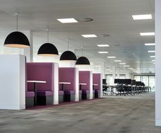 an empty office with purple and black chairs