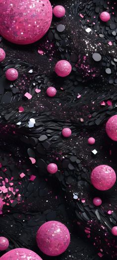 some pink and black balls are floating in the air with confetti on them