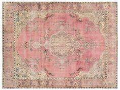 an antique rug with pink and beige colors