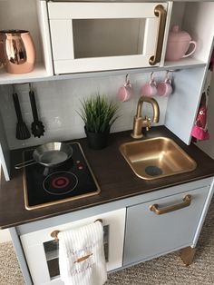 a kitchen with a stove top oven next to a sink