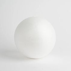 a white ball sitting on top of a table