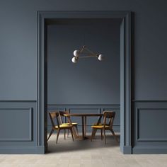 an open door leading to a dining room with two chairs and a table in it