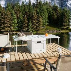 an outdoor table and chairs on a wooden dock