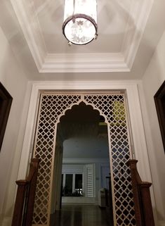 an open doorway with a light hanging from it's ceiling over the entrance way