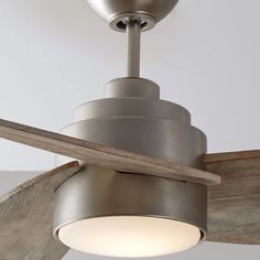 a ceiling fan with a light on top of it and a wooden blade hanging from the ceiling