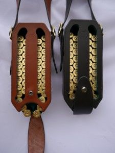 two brown and black purses with gold details on them sitting next to each other