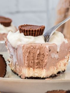 a piece of chocolate pie on a plate with a fork in it and some cookies