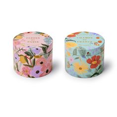 two tins with flowers on them sitting next to each other in front of a white background