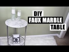 a marble table with two candles on it and the words diy faux marble table