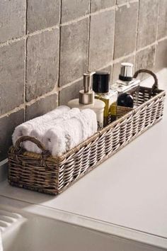 a wicker basket with towels and soaps on it