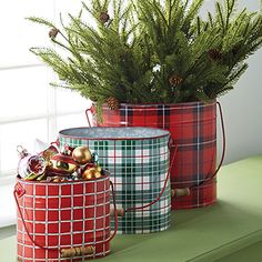 three tin cans with christmas decorations in them