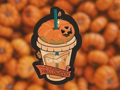 an orange pumpkin sitting in a bucket filled with candy