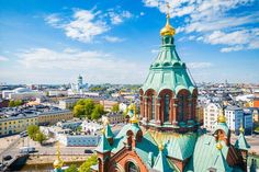 an aerial view of a church in the middle of a city with lots of tall buildings