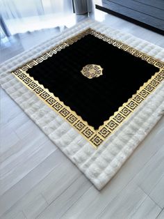 a black and gold area rug on the floor