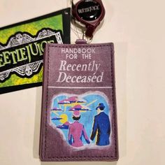 Keep Your Id On Hand With This Awesome Beetlejuice Handbook Retractable Id Lanyard! Make This The Perfect Gift For That Special Someone... Or Just Spoil Yourself! * * * * Features * * * * * Size 2.75" X 4.5" * Faux Leather * Featuring The Handbook For The Recently Deceased * Book Opens And Has Magnetic Closure * Id Slot In Book * Retracts Up To 23" * By Concept One X Beetlejuice * New Beetlejuice Handbook, Handbook For The Recently Deceased, Lanyard Id Holder, Id Lanyard, Document Holder, Key Card Holder, Id Holder, Beetlejuice, Magnetic Closure