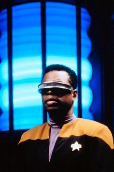 a man wearing a star trek uniform with a pair of glasses on his face