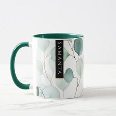 a green and white coffee mug with the name savannah printed on it's side