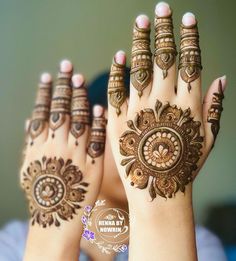 two hands with henna designs on them