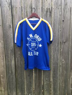 This shirt is simple yet looks awesome and is perfect for anyone that loves vintage sports clothing. It is in good condition with some snagging and some print chipping on the back, but has no rips, holes, stains or smells. Measurements: Pit to pit: 22 1/2 inches Collar to bottom front: 22 1/4 inches Collar to bottom back: 26 inches Size on tag: XL Blue Throwback Sports T-shirt, Blue Retro Sports T-shirt, Blue Throwback T-shirt For Sports, Throwback Blue Sports T-shirt, Retro Blue Sports T-shirt, Blue Throwback T-shirt For Sports Season, Retro Blue T-shirt For College, Blue Retro T-shirt For Sports Events, Retro Blue T-shirt For Sports Events