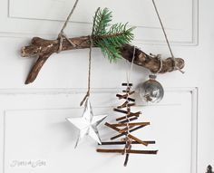 an ornament hanging from a branch on a door with other ornaments in it