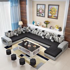 a living room with black and white couches, coffee table and pictures on the wall