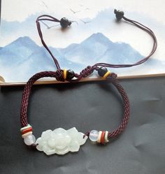 "Weave Rope lotus flower Natural Burmese jadeite jade,stone bead bracelet,Grade A,amulet,protector,mood,good lucky gift,gemstone,Yoga Jewelry material: natural jadeite jade stone,rope  Size:  flower : approx. 15mmx28mmx5mm Rope Color: brown color length:6\"-9\" style: weave rope,adjustable bracelet Price: one bracelet ❤ If you want other length Bracelet, Please connect me free. ❤Please read the store policy before purchase. ❤ Thank you for visiting my shop!" White Jade Spiritual Bracelets, White Spiritual Jade Bracelets, White Jade Jewelry For Meditation, Spiritual White Jade Bracelets, White Spiritual Bracelet For Good Luck, Spiritual White Bracelets For Good Luck, Spiritual White Bracelet For Good Luck, White Jade Bracelets For Meditation, Traditional White Jewelry For Good Luck