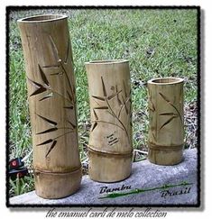 three bamboo vases sitting on top of a towel