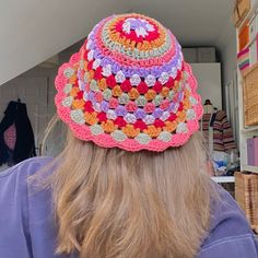 a woman wearing a colorful crocheted hat