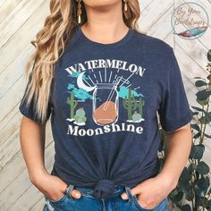 a woman wearing a t - shirt that says watermelon is moonshing