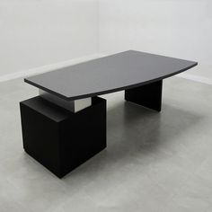 a black table sitting on top of a white floor