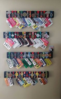 the wall is covered with many different colored tags and numbers on it, along with several magnets attached to each board