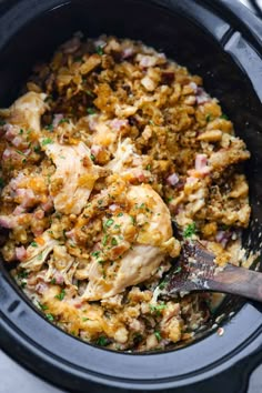 a slow cooker filled with chicken and stuffing