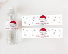 two water bottle labels with santa hats and snowflakes on them next to a plastic bottle