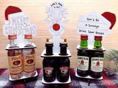 three bottles of alcohol sitting on top of a table next to christmas signs and decorations