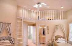 two beds in a room with pink carpeting and white railings on the ceiling