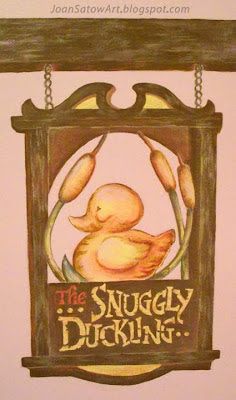 the snuggly duckling sign is hanging on the wall