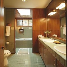 A mid-century modern bathroom featuring seamlessly integrated built-in cabinets and drawers, providing ample storage while maintaining a clean, streamlined appearance4 Yellow Mid Century Bathroom, Green Mcm Bathroom, Mid Century Toilet Design, Mid Century Modern Blue Bathroom, Mid Century Modern Bathroom Green, Retro Modern Bathroom, Midcentury Bathroom Design, 70s Bathroom Aesthetic, Small Mid Century Bathroom