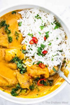 a white bowl filled with rice and chicken curry