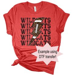 a red shirt with an image of a football on it and the words wild cats, wildcats