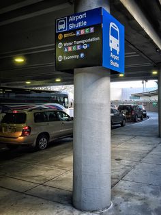 an airport parking garage with cars parked in it