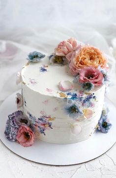 there is a white cake with flowers on it