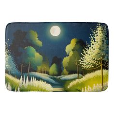 a bath mat with a painting of a forest at night and the moon in the sky