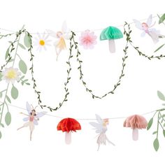 paper flowers and tinkerbells are hanging from a string with leaves on it