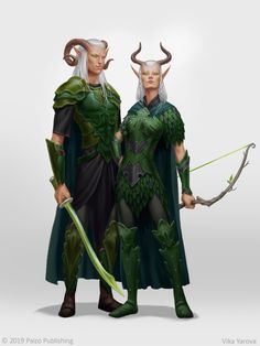 two men dressed in green and black standing next to each other with horns on their heads