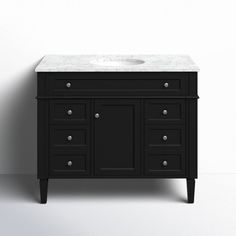 a white sink sitting on top of a black cabinet