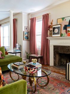 a living room filled with furniture and a fire place in the middle of the room