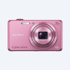 a pink digital camera sitting on top of a white surface