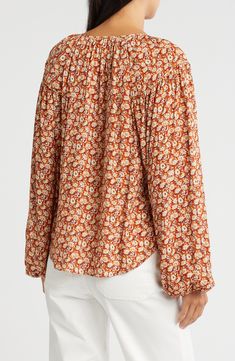 Rouleau-style buttons and a vivid floral pattern add romantic touches to this flowy top framed by voluminously ballooned sleeves. Button half placket Split neck Long sleeves Curved hem 100% viscose Dry clean Imported Floral Balloons, Balloon Sleeve Top, Flowy Top, Flowy Tops, Nordstrom Rack, Floral Pattern, Sleeve Top, Split, Dry Clean